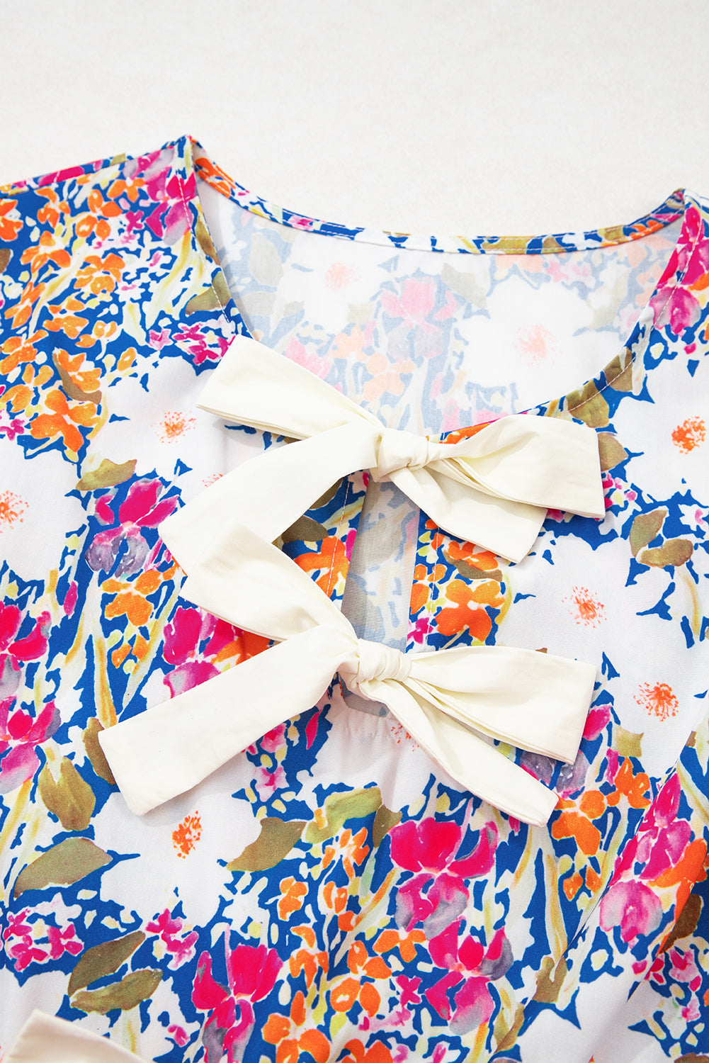 Floral Bow Tie Sleeveless Peplum Blouse