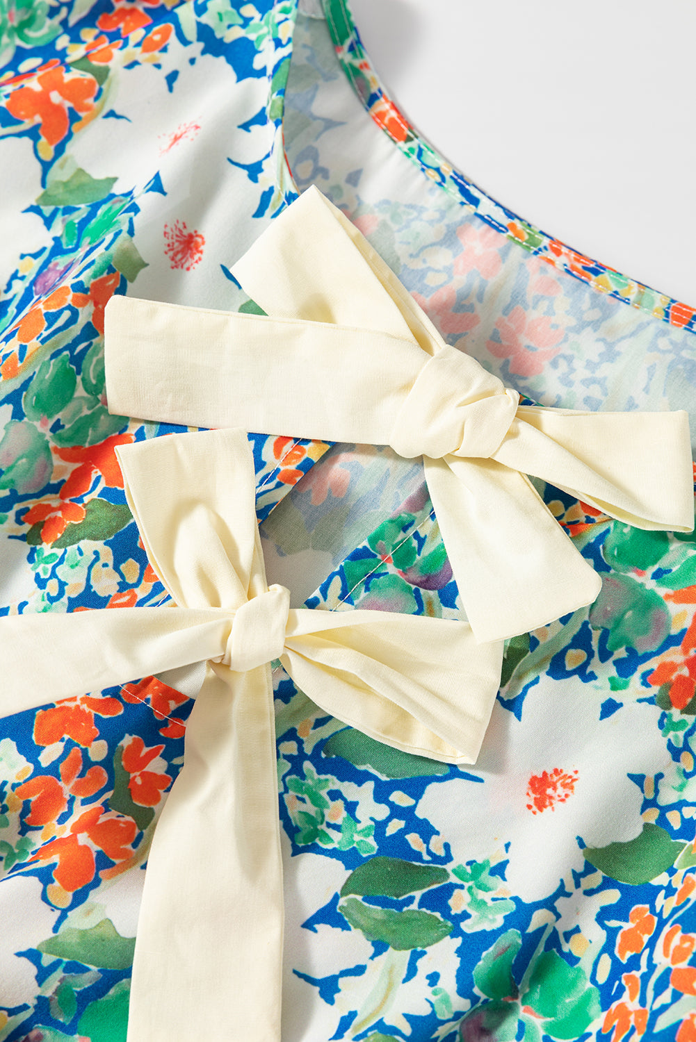 Floral Bow Tie Sleeveless Peplum Blouse